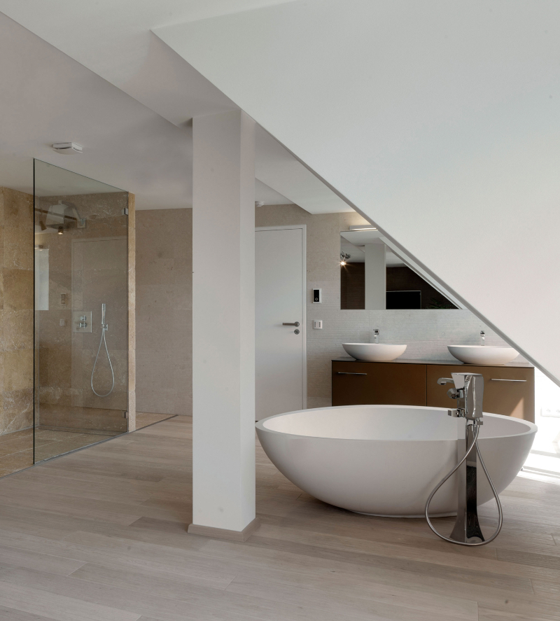 Master Bathroom Designs by Berlins Finest Interior Designers PENTHOUSE PARISER STRASS by Carlo Berlin, a elegant high end bathroom with a large white bathtub and a modern shower.