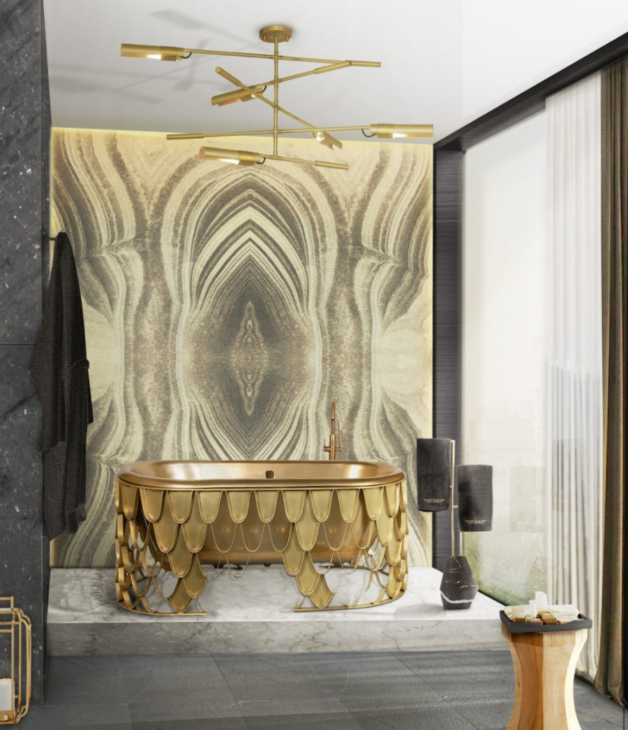Modern bathroom with a golden detailed bathtub and an exquisite golden lamp