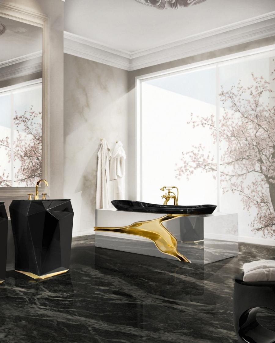 Modern bathroom with a detailed bathtub with gold and a black and gold freestanding