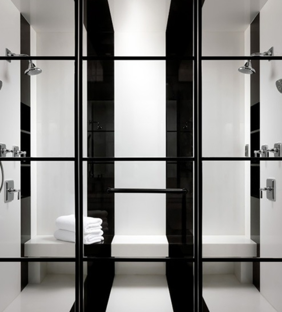 Luxury bathroom by Lori Morris Design. This walk-in-bathroom is white with two large black lines.
