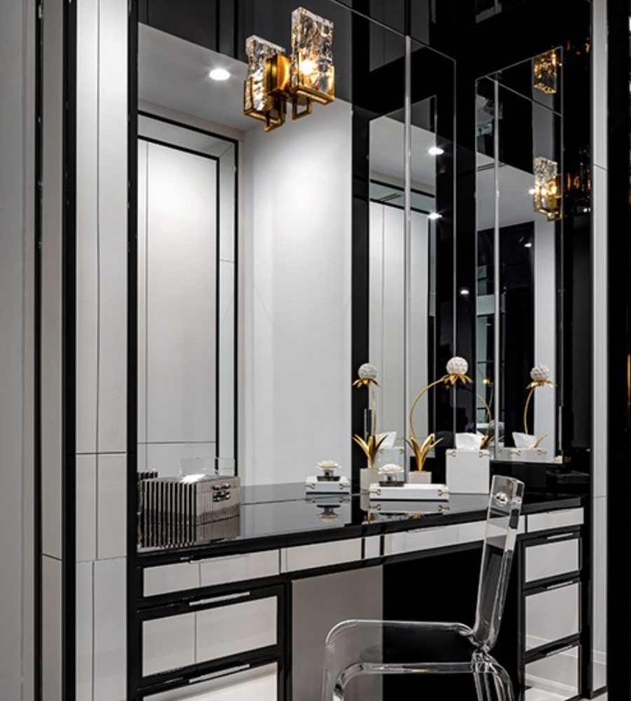 Luxury bathroom by Lori Morris Design. This bathroom has a white and black makeup table and a chair transparent.