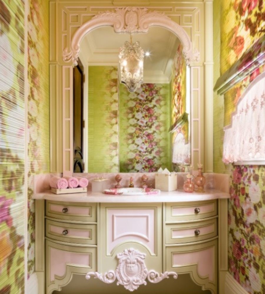 Luxury bathroom by Lori Morris Design. This colorful bathroom with green walls with pink flowers has a pink and green vanity with a pink countertop and a big mirror.