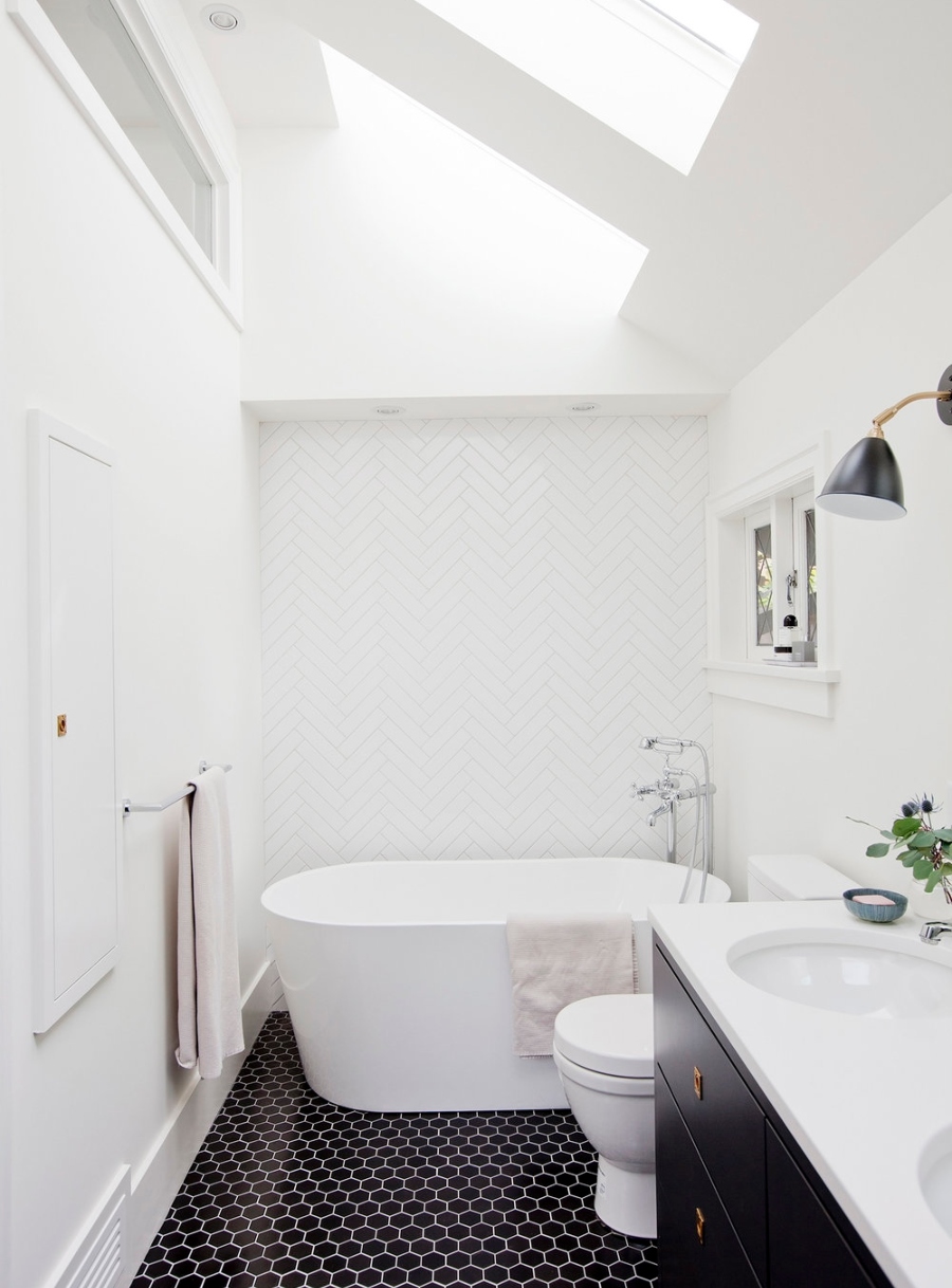 Bathroom Design With Sophie Burke Design. White bathroom with a white bathtub and black floor.