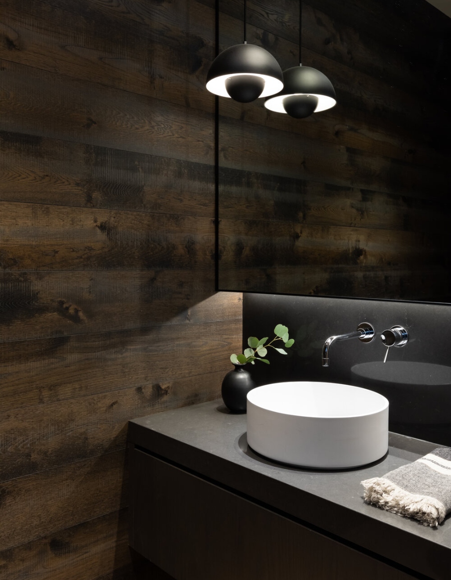 Bathroom Design With Sophie Burke Design. Dark bathroom with painel wood in walls and a white sink.