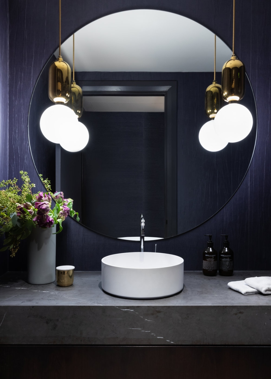 Bathroom Design With Sophie Burke Design. Dark babthroom with a dark blue wall and a small white sink.