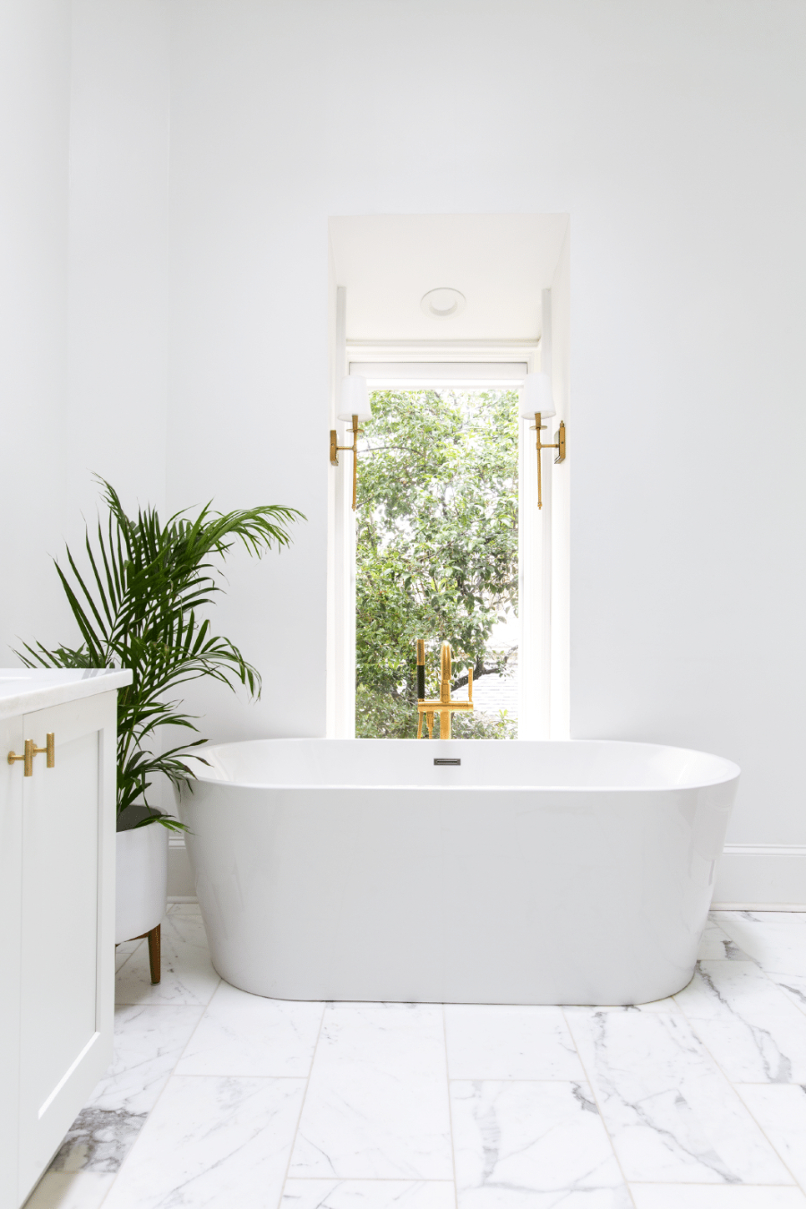 Bathroom Interior Design: Ashton Taylor Interiors. A white bathtub in a overall white design. The furniture and walls are white, and the floor is in white marble.