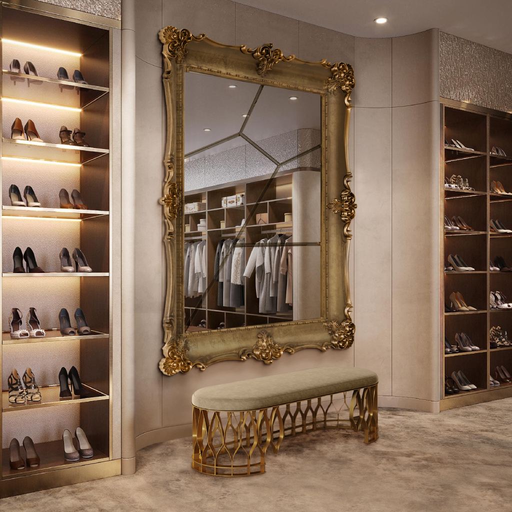 Luxury closet with Mecca Bench by BRABBU and D. Dinis Mirror by Boca do Lobo, featuring warm tones, rich textures, and organized designer fashion.