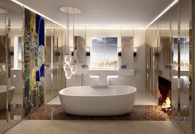 bathroom by studio gronda with white bathtub and fireplace