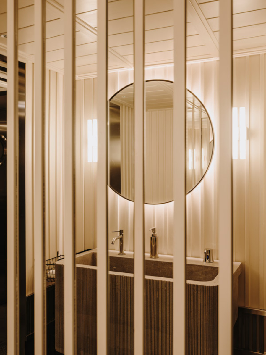 bathroom by Astet with round mirror