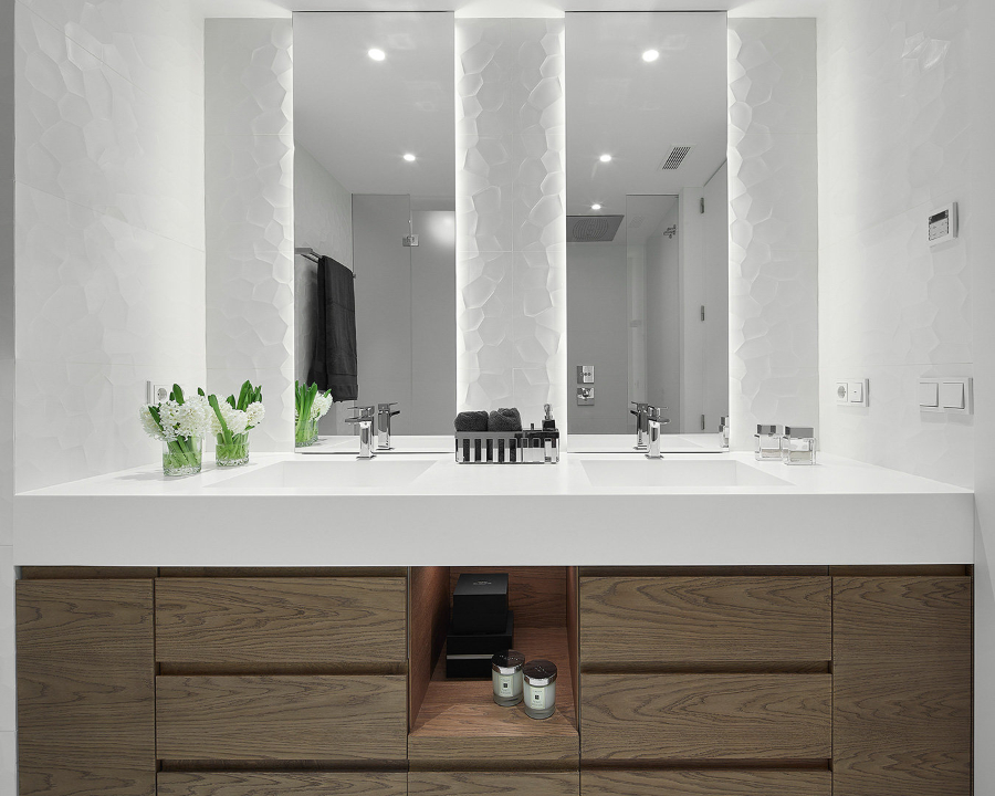 bathroom by Molins Design with white sink and brown cabinets